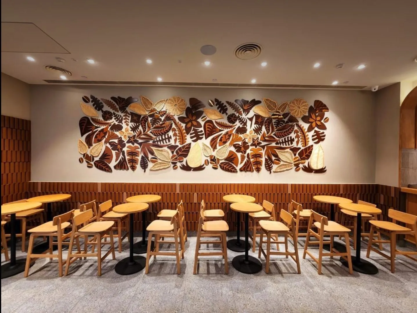Full view of the cane, wood and gold coffee-botanical installation at Starbucks HiLITE Mall, Kozhikode, store interior